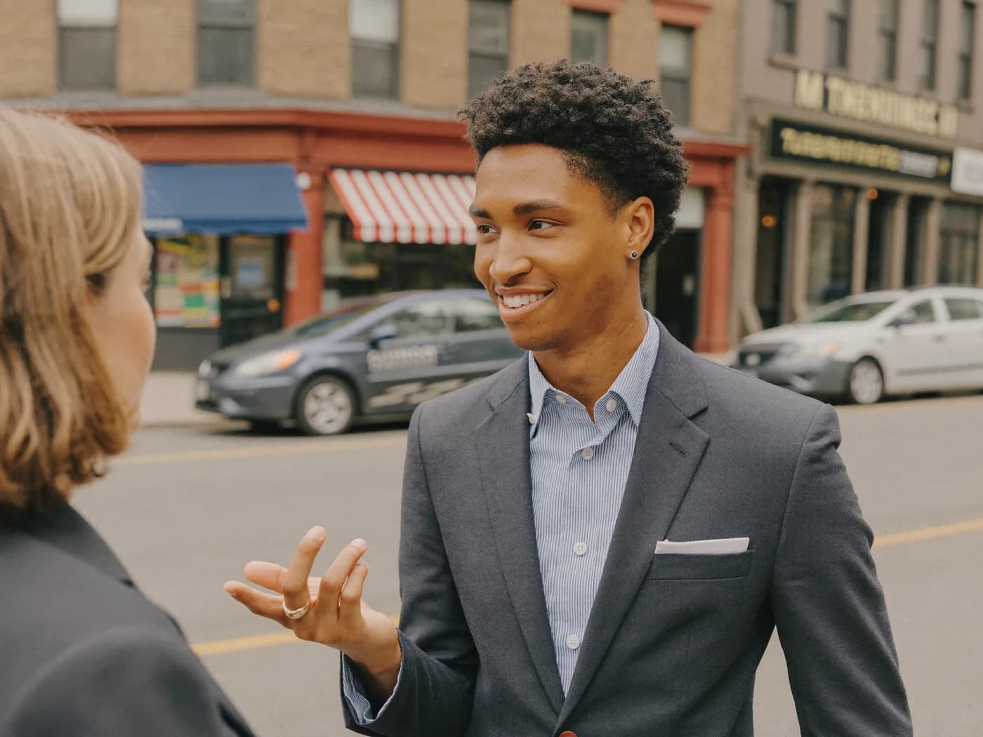A field-marketing rep talking with a customer on a downtown Halifax street.